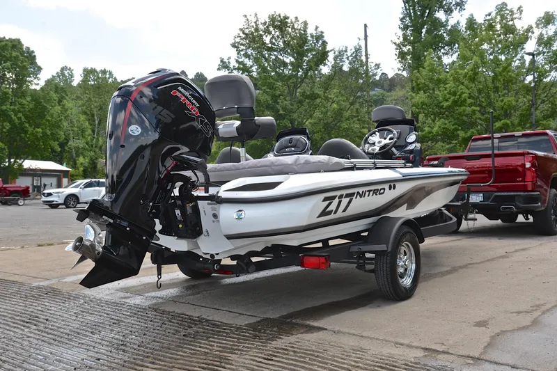 Slide: The Image of 2025 Nitro Z17 boat on trailer with powerful outboard motor, parked outdoors. - 13