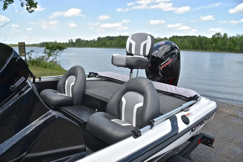 Slide: The Image of 2025 Nitro Z17 boat with sleek seating and powerful engine by a serene lake. - 17
