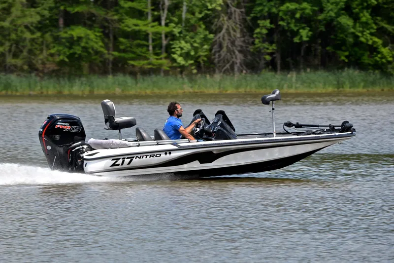 Slide: The Image of 2025 Nitro Z17 boat speeding on a lake with lush green forest backdrop. - 3
