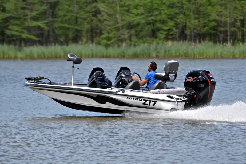 Slide: The Image of 2025 Nitro Z17 boat speeding on a lake with lush green background. - 4