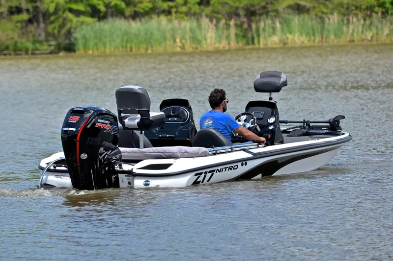 Slide: The Image of Man driving a 2025 Nitro Z17 boat on a calm lake. - 7