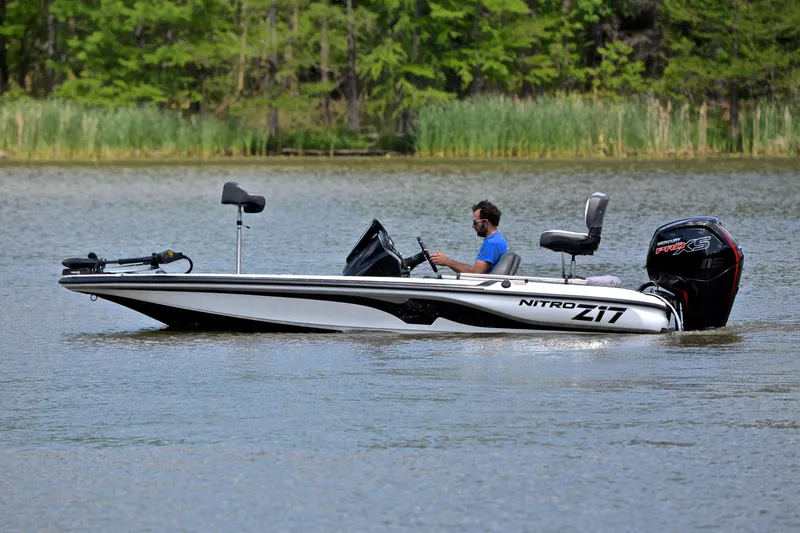 Slide: The Image of 2025 Nitro Z17 boat on a lake, featuring sleek design and powerful engine. - 8