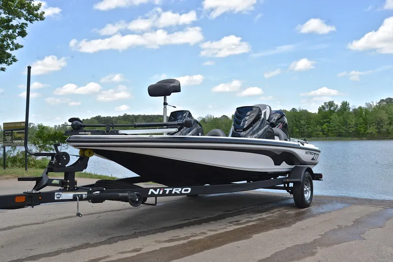 Slide: The Image of 2025 Nitro Z17 boat on trailer by a scenic lake under a blue sky. - 9
