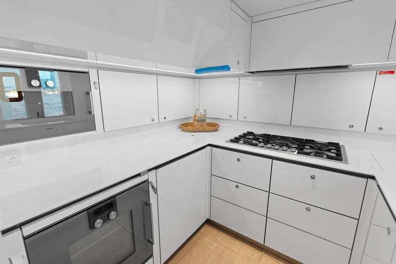 Slide: The Image of Modern kitchen in 2024 Sunreef 80 Power yacht with sleek white cabinetry and gas stove. - 101