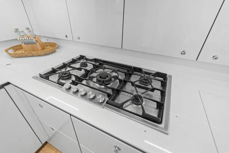 Slide: The Image of Modern kitchen stove in 2024 Sunreef 80 Power yacht, featuring sleek cabinetry and knife set. - 102