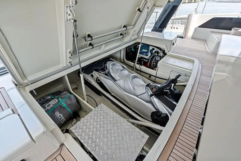 Slide: The Image of 2024 Sunreef 80 Power yacht with open storage compartment revealing a jet ski. - 115