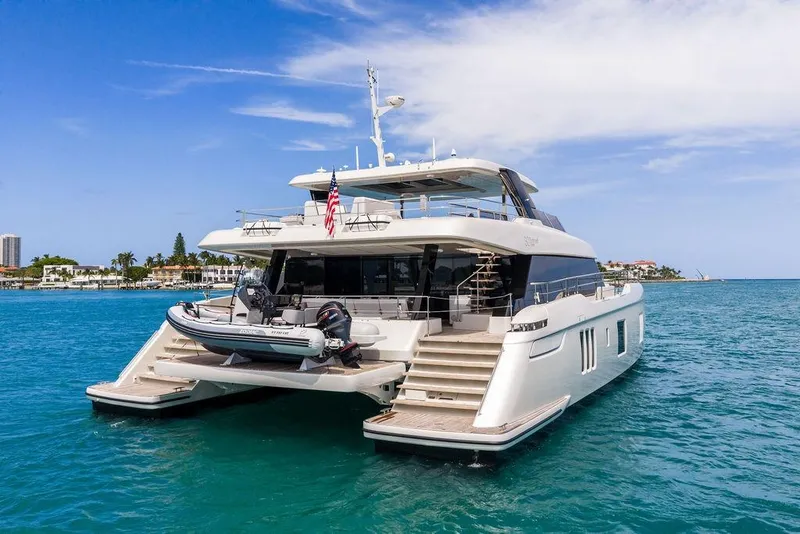 Slide: The Image of Luxurious 2024 Sunreef 80 Power yacht on serene blue waters, showcasing elegant design. - 13