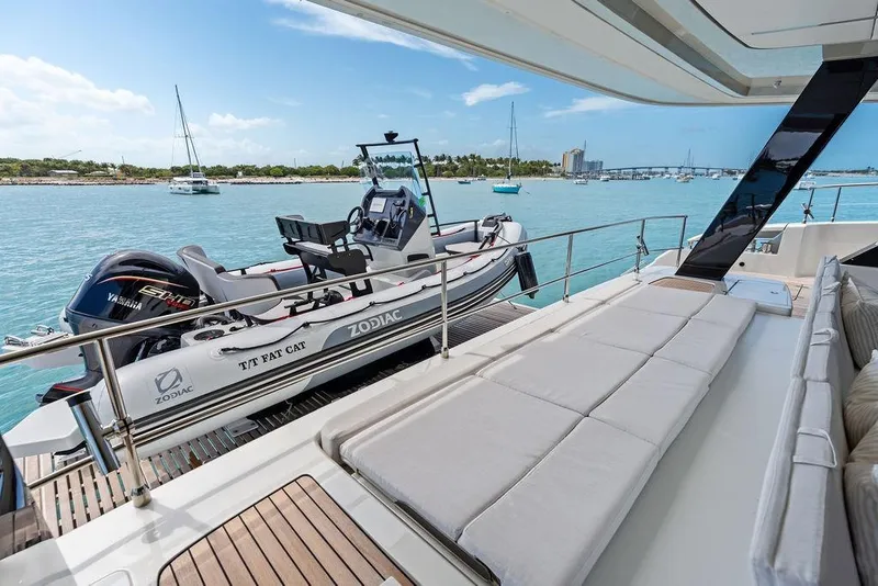 Slide: The Image of Luxurious Sunreef 80 Power yacht deck with Zodiac tender, 2024 model, in serene waters. - 27