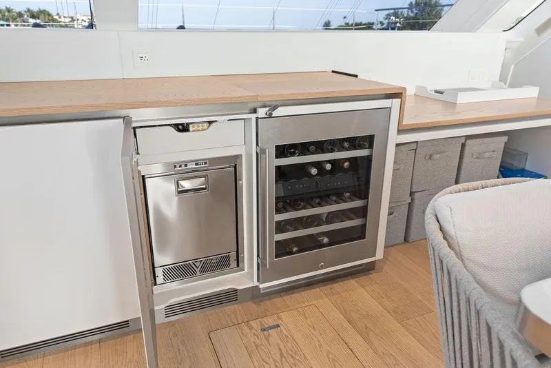 Slide: The Image of Luxurious interior of 2024 Sunreef 80 Power yacht featuring a modern kitchen with wine cooler. - 51