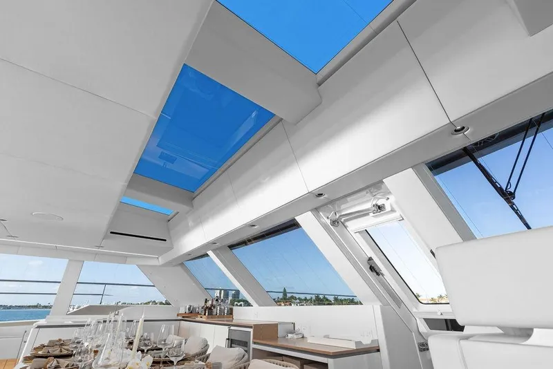 Slide: The Image of Luxurious interior of 2024 Sunreef 80 Power yacht with panoramic windows and elegant dining setup. - 54