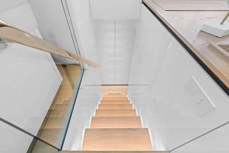 Slide: The Image of Modern staircase with wooden steps and sleek white walls on Sunreef 80 Power yacht, 2024 model. - 57