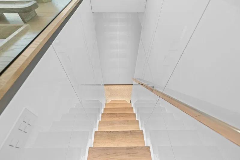 Slide: The Image of Staircase with wooden steps and sleek white walls on Sunreef 80 Power yacht, 2024 model. - 58