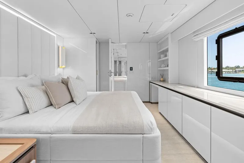 Slide: The Image of Luxurious Sunreef 80 Power 2024 yacht bedroom with elegant white interior and ocean view. - 81