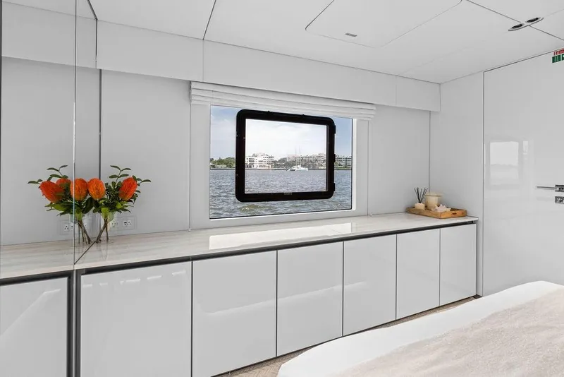 Slide: The Image of Luxurious interior of 2024 Sunreef 80 Power yacht with sleek cabinetry and scenic window view. - 85
