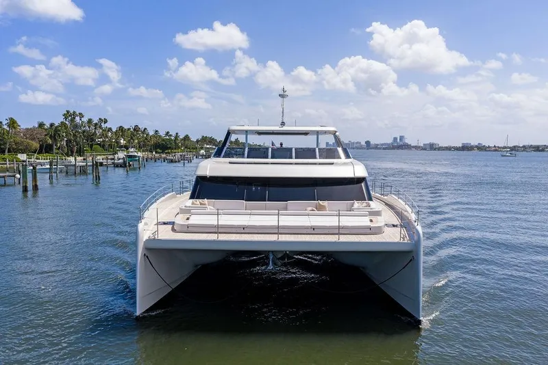 Slide: The Image of 2024 Sunreef 80 Power yacht cruising on a sunny day, surrounded by calm waters. - 9