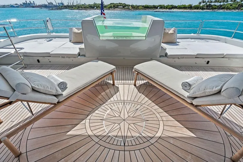 Slide: The Image of Luxurious Sunreef 80 Power yacht deck with sun loungers, 2024 model, overlooking serene blue waters. - 92