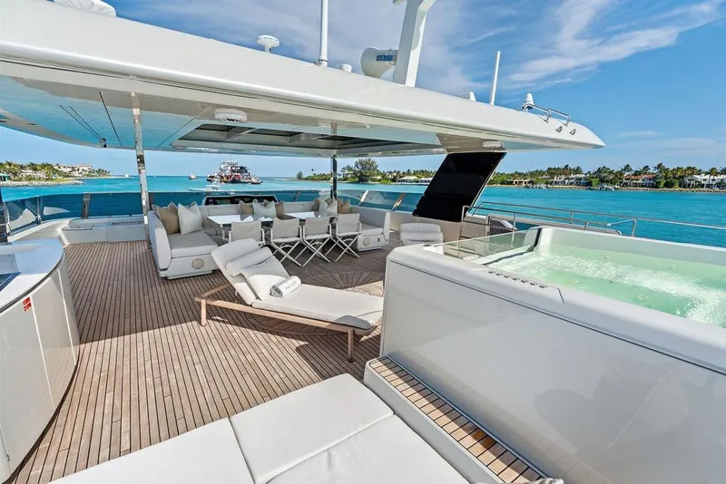 Slide: The Image of Luxurious Sunreef 80 Power yacht deck with jacuzzi, lounge chairs, and ocean view, 2024 model. - 93