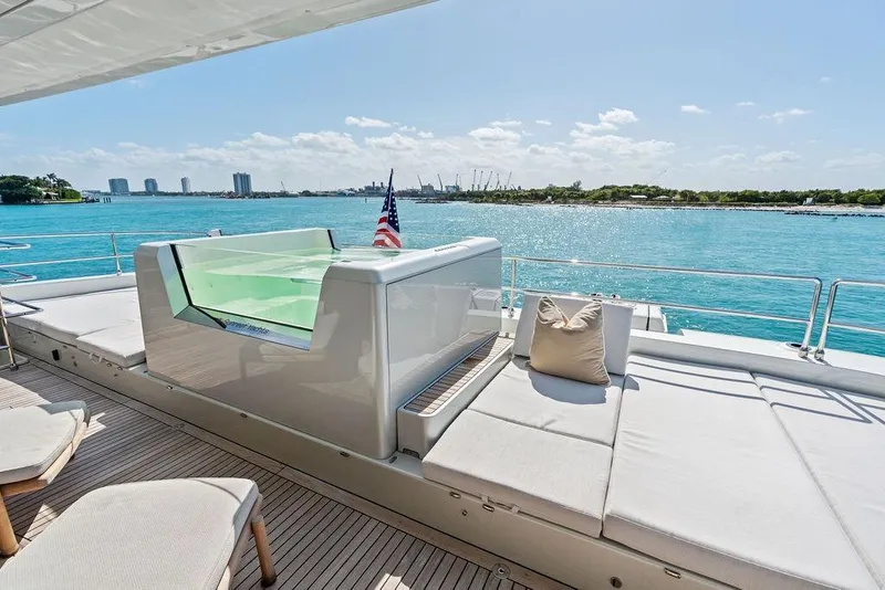 Slide: The Image of Luxurious Sunreef 80 Power yacht deck with seating, overlooking serene blue waters, 2024 model. - 94