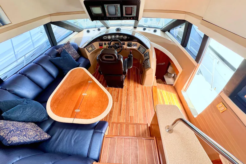 Slide: The Image of Luxurious interior of 1998 Carver 530 Voyager Pilothouse with plush seating and helm. - 4