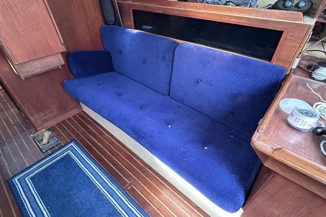 Slide: The Image of 1984 Pearson 34 sailboat interior galley with wooden cabinetry, sink, and stove. - 10