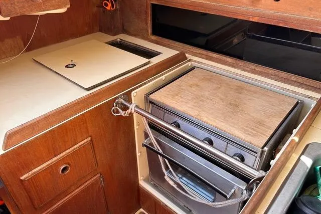 Slide: The Image of Interior view of 1984 Pearson 34 sailboat cabin with wooden accents and blue sky above. - 14