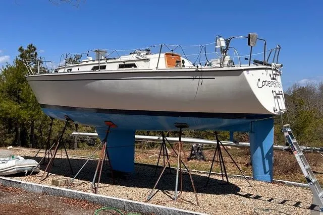 Slide: The Image of Engine mount detail on a 1984 Pearson 34 sailboat, featuring a metal bracket and marine hose. - 19