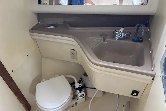 Slide: The Image of Interior of a 1984 Pearson 34 sailboat with wood paneling and blue upholstery. - 6