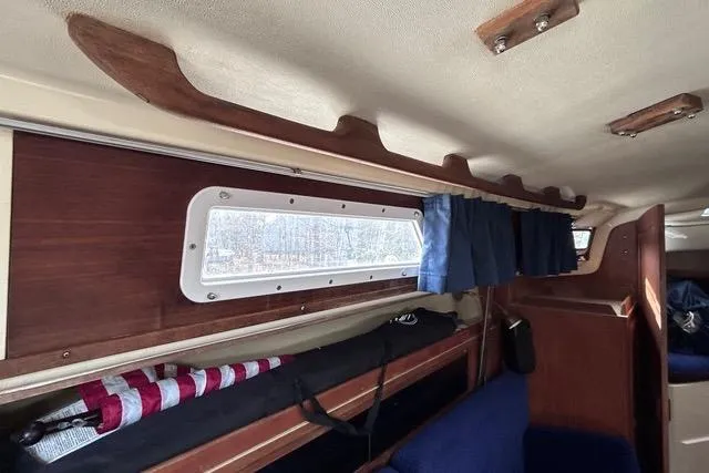 Slide: The Image of Compact bathroom in a 1984 Pearson 34 sailboat, featuring a sink and marine toilet. - 8