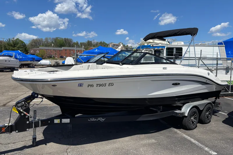 The Image of 2024 Sea Ray SPX 210 boat on trailer under clear blue sky. - 0