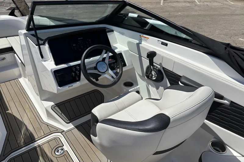 Slide: The Image of 2024 Sea Ray SPX 210 boat cockpit with modern steering and controls. - 11