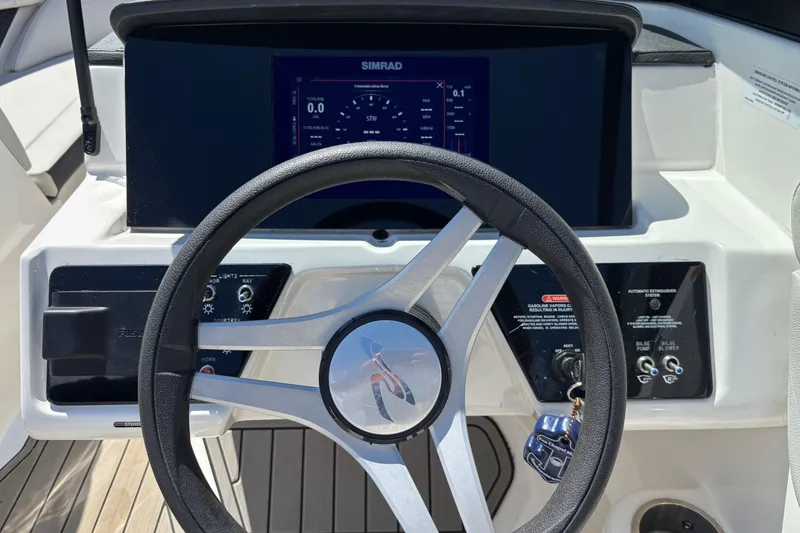 Slide: The Image of 2024 Sea Ray SPX 210 boat dashboard with steering wheel and control panel. - 12