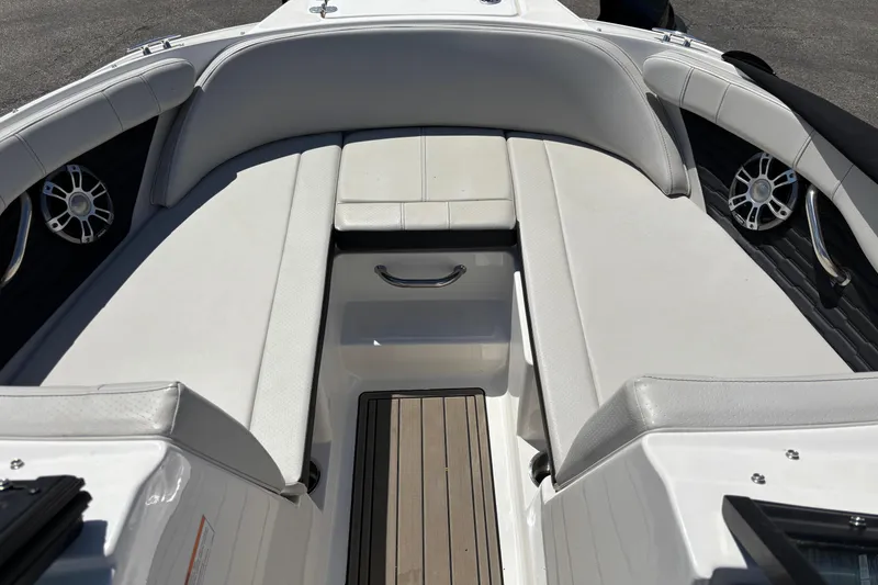 Slide: The Image of 2024 Sea Ray SPX 210 boat interior with cushioned seating and sleek design. - 13