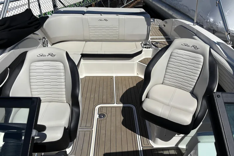 Slide: The Image of 2024 Sea Ray SPX 210 boat interior with luxurious seating and sleek design. - 14