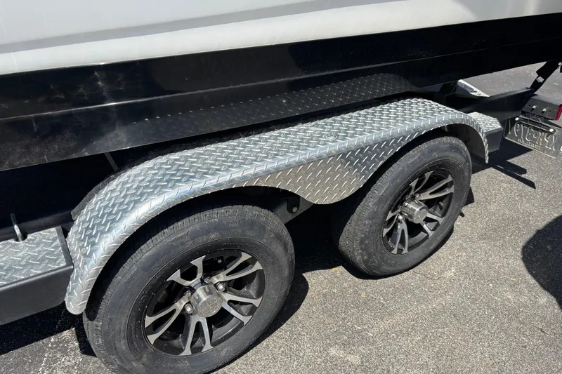 Slide: The Image of 2024 Sea Ray SPX 210 trailer with dual wheels and diamond plate fender. - 3