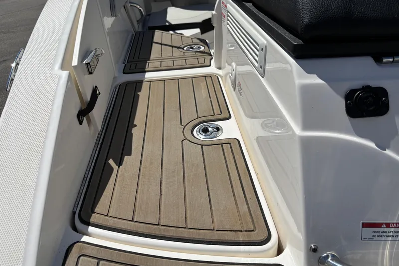 Slide: The Image of 2024 Sea Ray SPX 210 boat deck with teak-style flooring and sleek design. - 7