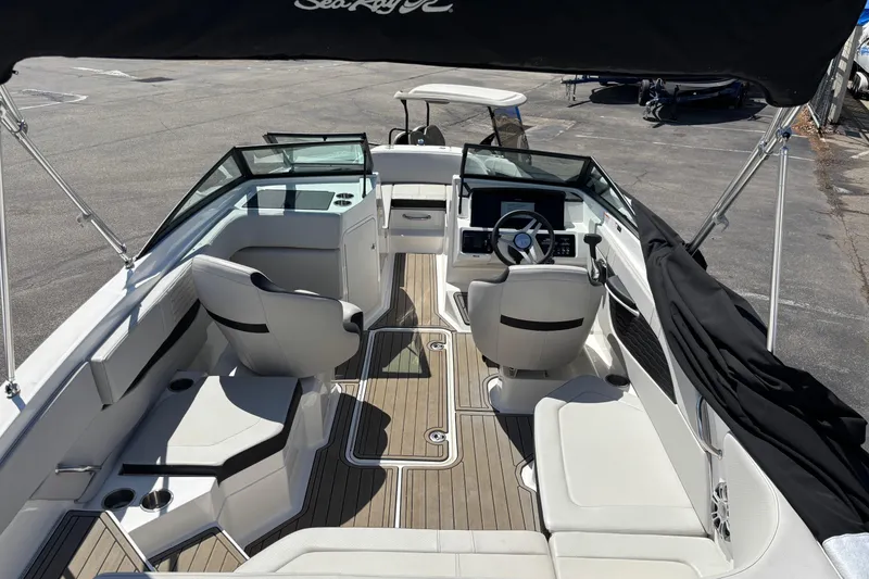 Slide: The Image of 2024 Sea Ray SPX 210 boat interior with sleek seating and modern dashboard. - 8