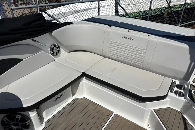 Slide: The Image of 2024 Sea Ray SPX 210 boat interior with white seating and cup holders. - 9