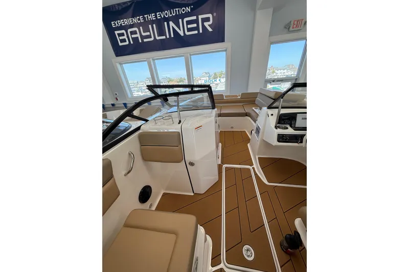 Slide: The Image of 2026 Bayliner D22 boat interior with tan seating and modern dashboard. - 10