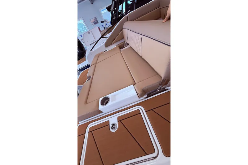 Slide: The Image of 2026 Bayliner D22 boat interior with tan seating and sleek design. - 11