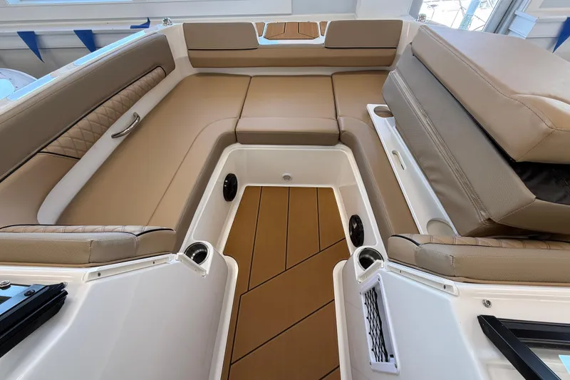 Slide: The Image of 2026 Bayliner D22 boat interior with tan seating and wood-style flooring. - 5
