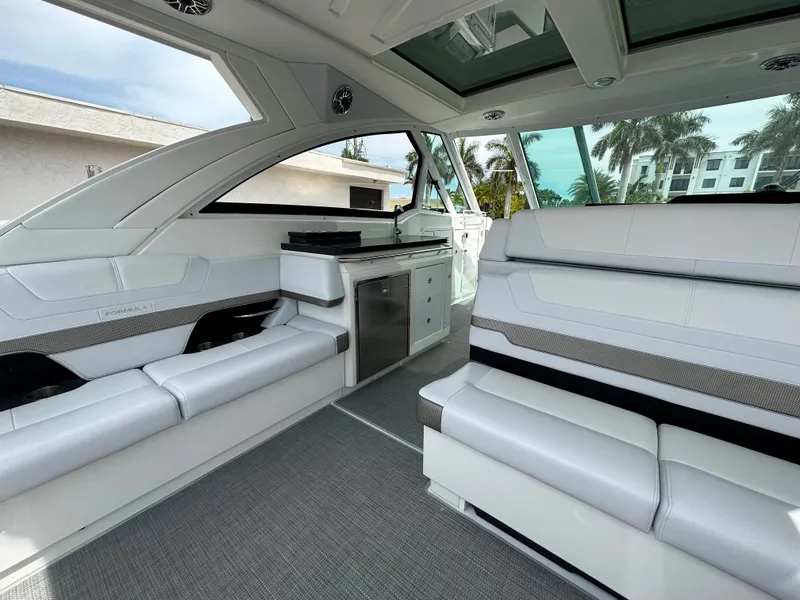 Slide: The Image of 2021 Formula 380 SSC boat interior with white seating and kitchenette. - 17