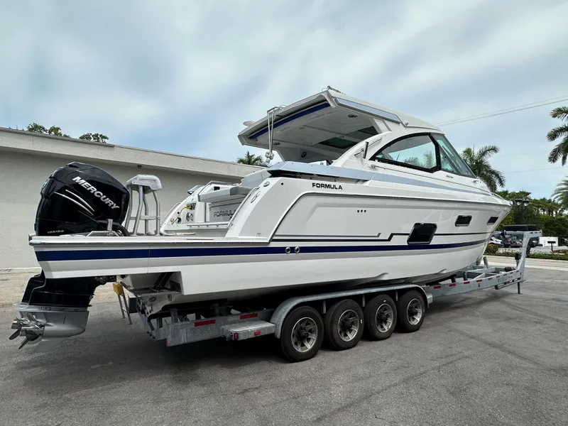 Slide: The Image of 2021 Formula 380 SSC boat on a trailer with Mercury outboard engines. - 4
