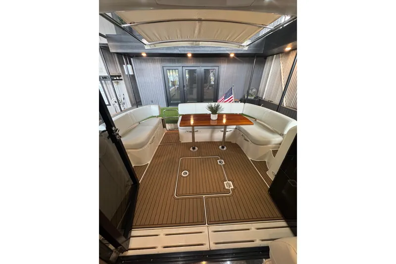 Slide: The Image of Luxurious interior of 2016 Carver C37 Coupe yacht with elegant seating and wooden table. - 10