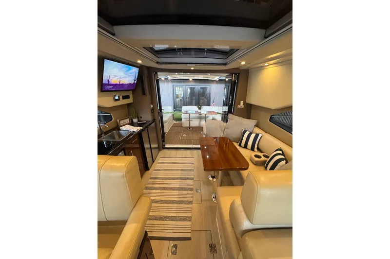 Slide: The Image of Luxurious interior of 2016 Carver C37 Coupe yacht with seating, table, and TV. - 11