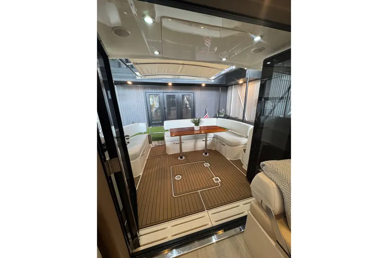 Slide: The Image of Luxurious interior of 2016 Carver C37 Coupe yacht with elegant seating and wooden flooring. - 15