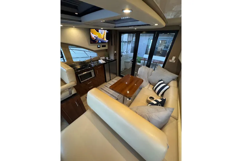 Slide: The Image of Luxurious interior of 2016 Carver C37 Coupe yacht with cozy seating and modern amenities. - 16