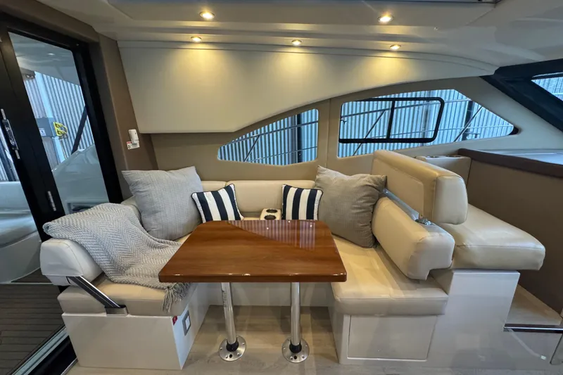 Slide: The Image of Luxurious interior of 2016 Carver C37 Coupe with plush seating and elegant wooden table. - 17