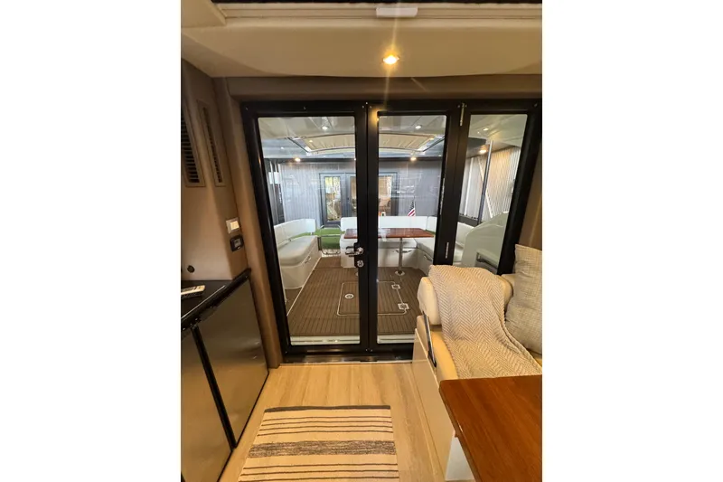 Slide: The Image of Interior view of 2016 Carver C37 Coupe yacht, featuring cozy seating and elegant design. - 19