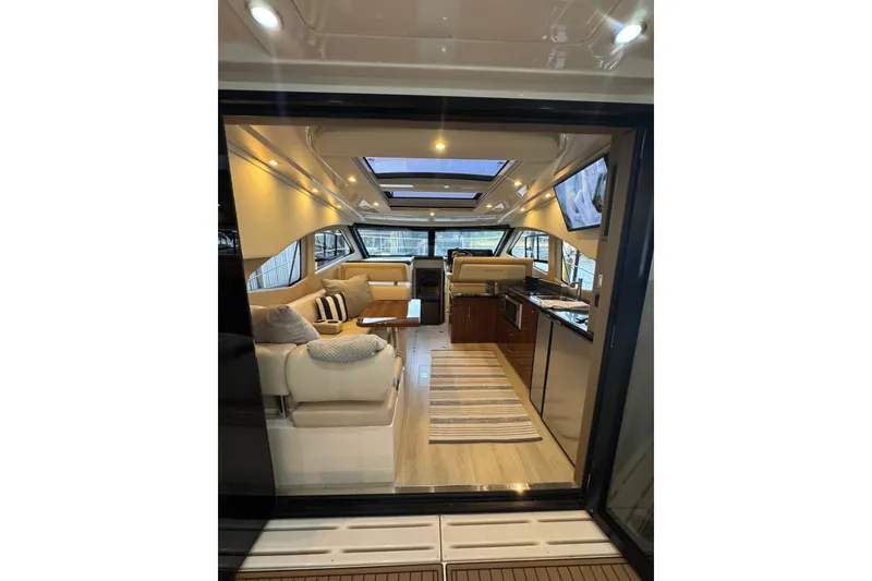 Slide: The Image of Luxurious interior of 2016 Carver C37 Coupe yacht with modern furnishings and ambient lighting. - 21
