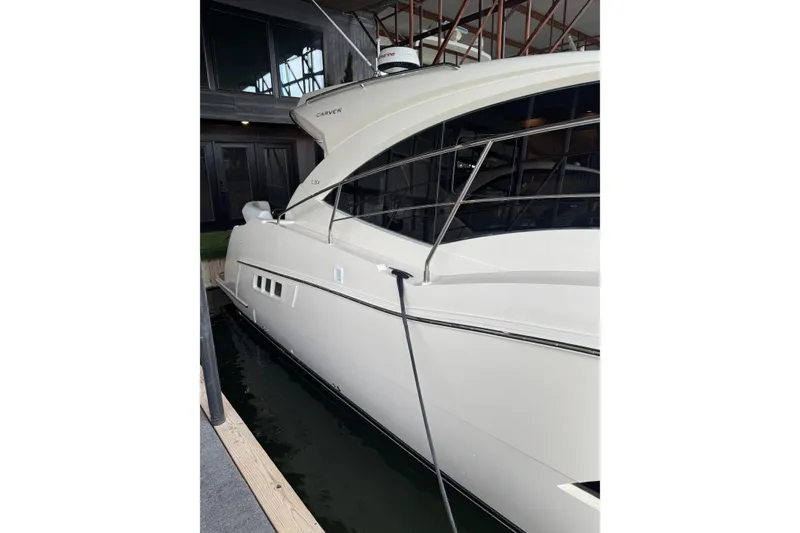Slide: The Image of 2016 Carver C37 Coupe yacht docked indoors, showcasing sleek design and modern features. - 35